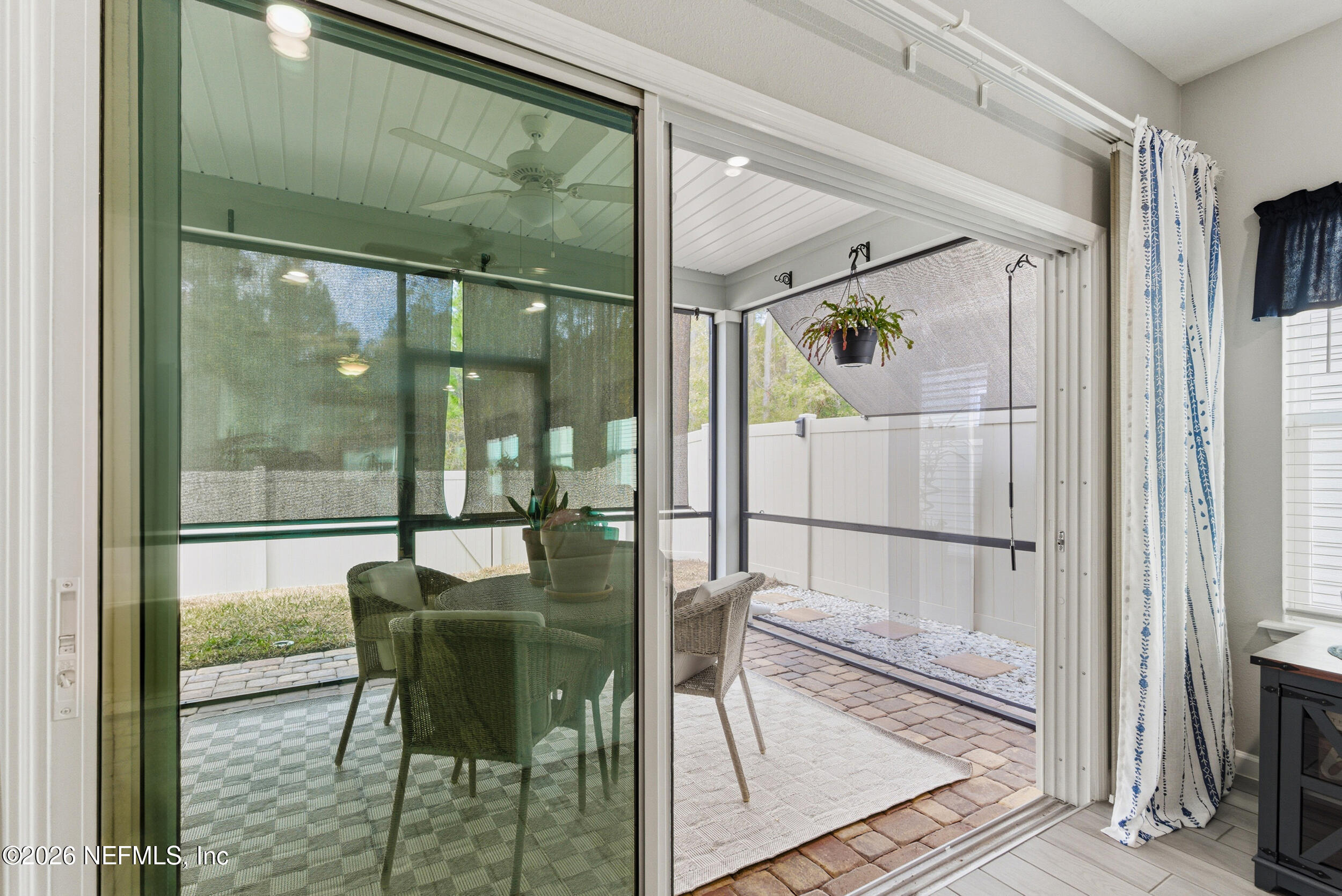 6507 Longleaf Branch Drive Jacksonville, FL 32222 - Photo 30 of 34 a view of a dining room with furniture wooden floor and a floor to ceiling window