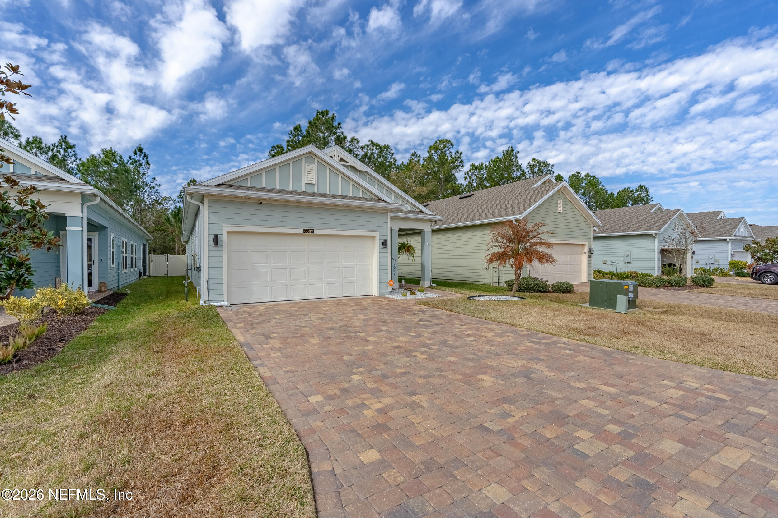 6507 Longleaf Branch Drive Jacksonville, FL 32222 - Photo 3 of 34 a front view of a house with a yard and garage