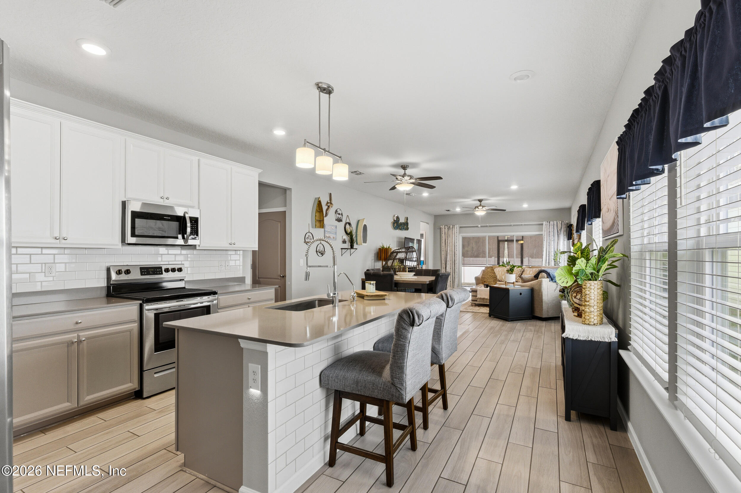 6507 Longleaf Branch Drive Jacksonville, FL 32222 - Photo 6 of 34 a kitchen with sink refrigerator and microwave