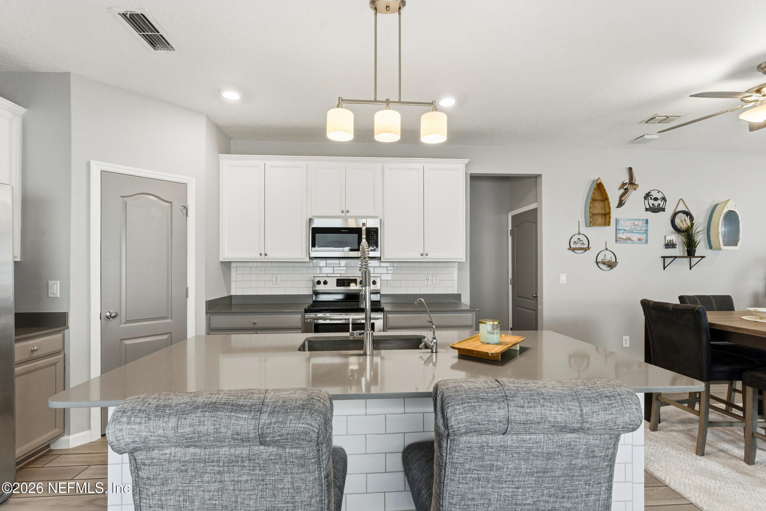 6507 Longleaf Branch Drive Jacksonville, FL 32222 - Photo 7 of 34 a kitchen with stainless steel appliances kitchen island granite countertop a refrigerator and stove