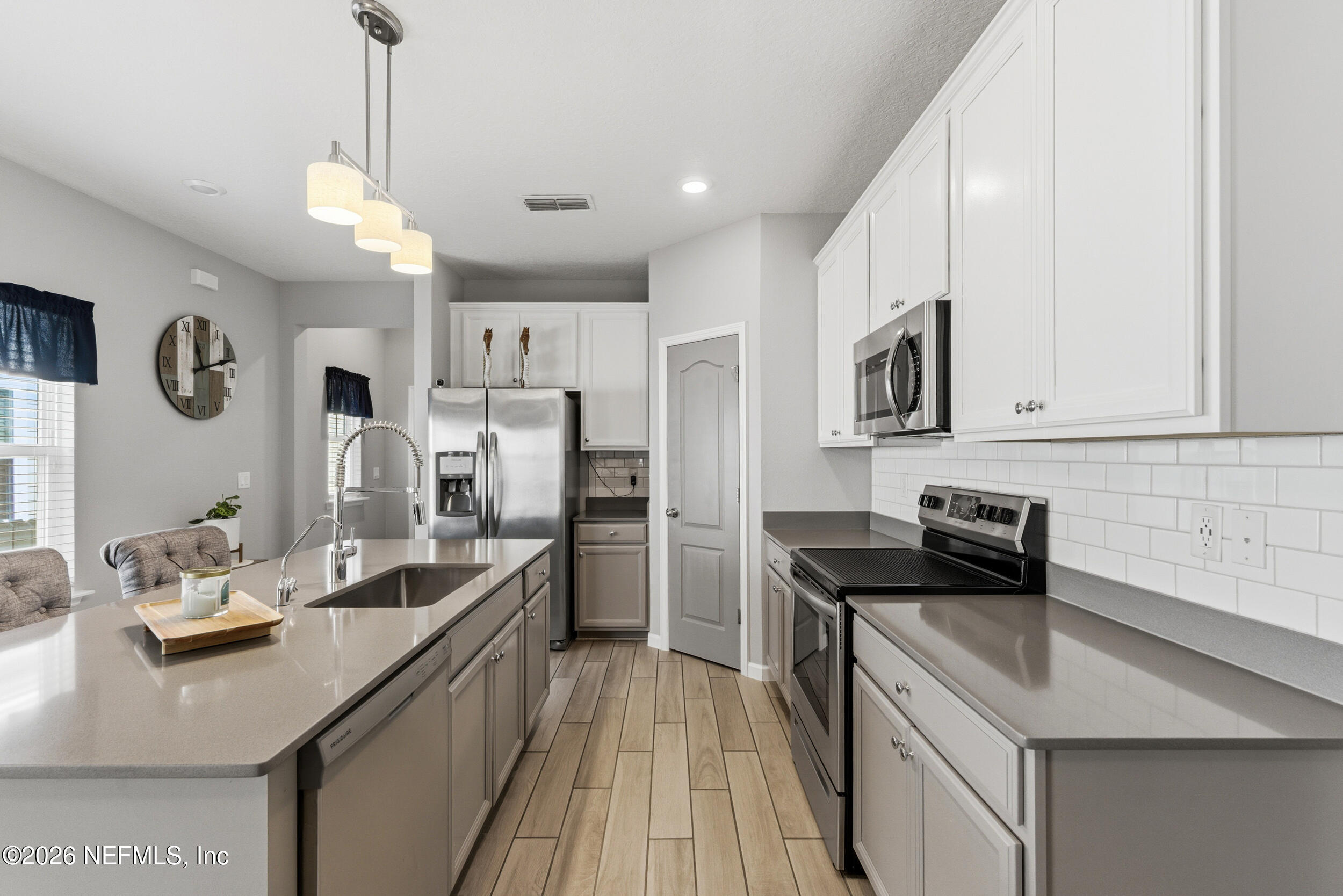 6507 Longleaf Branch Drive Jacksonville, FL 32222 - Photo 9 of 34 a kitchen with a sink stove and refrigerator