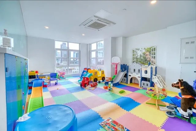 a view of a room with gym equipment and floor to ceiling window