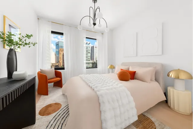 a bedroom with bed and a chandelier