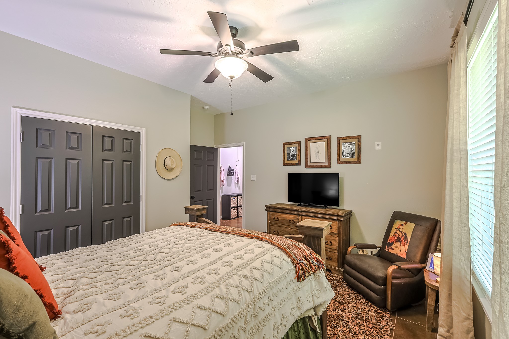 6409 Medley Road New Waverly, TX 77358 - Photo 31 of 50 This secondary bedroom has a large window overlooking the backyard. It has high ceilings, a double door closet and stained concrete floors and is big enough for a king size bedroom set and other furniture.