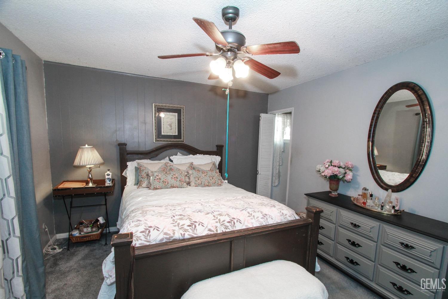 Undisclosed Address Bakersfield, CA 93306 - Photo 15 of 19 a bedroom with a bed and a chandelier