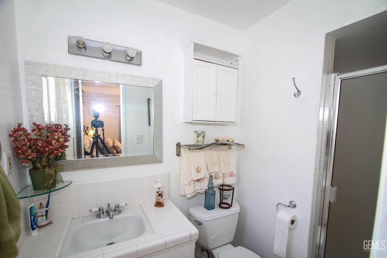 Undisclosed Address Bakersfield, CA 93306 - Photo 16 of 19 a bathroom with a sink and a mirror