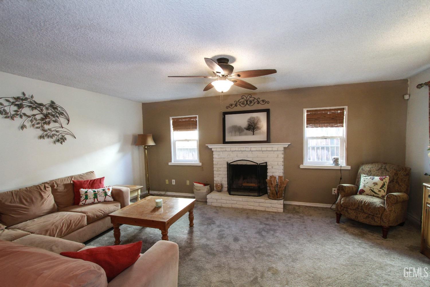 Undisclosed Address Bakersfield, CA 93306 - Photo 4 of 19 a living room with furniture and a fireplace