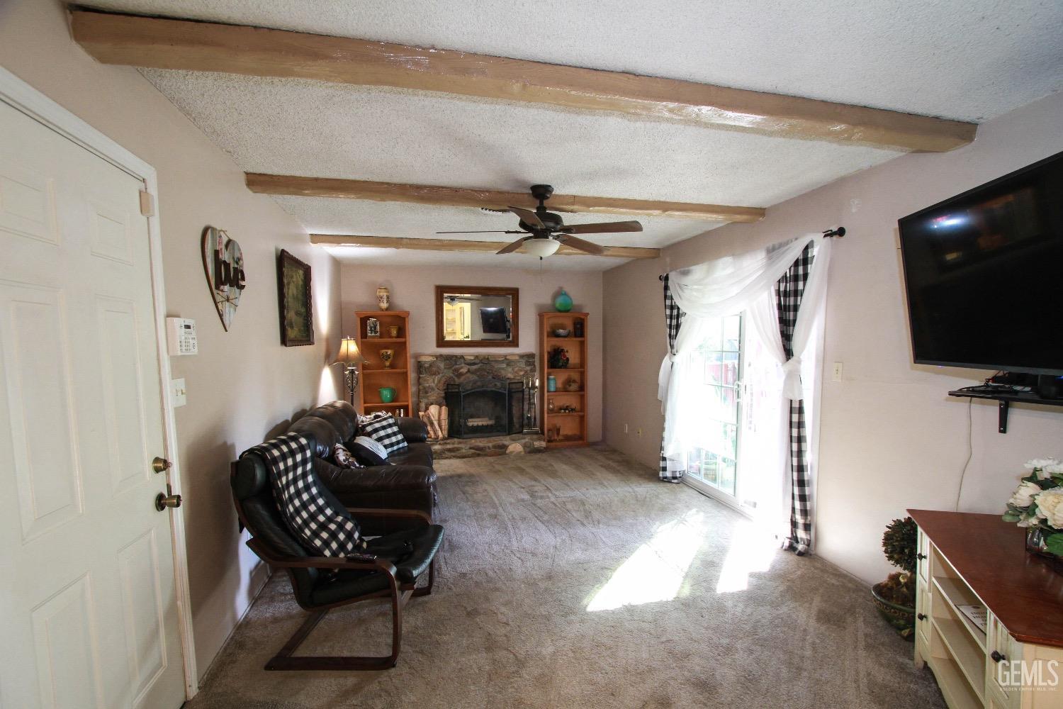 Undisclosed Address Bakersfield, CA 93306 - Photo 8 of 19 a living room with furniture and a flat screen tv