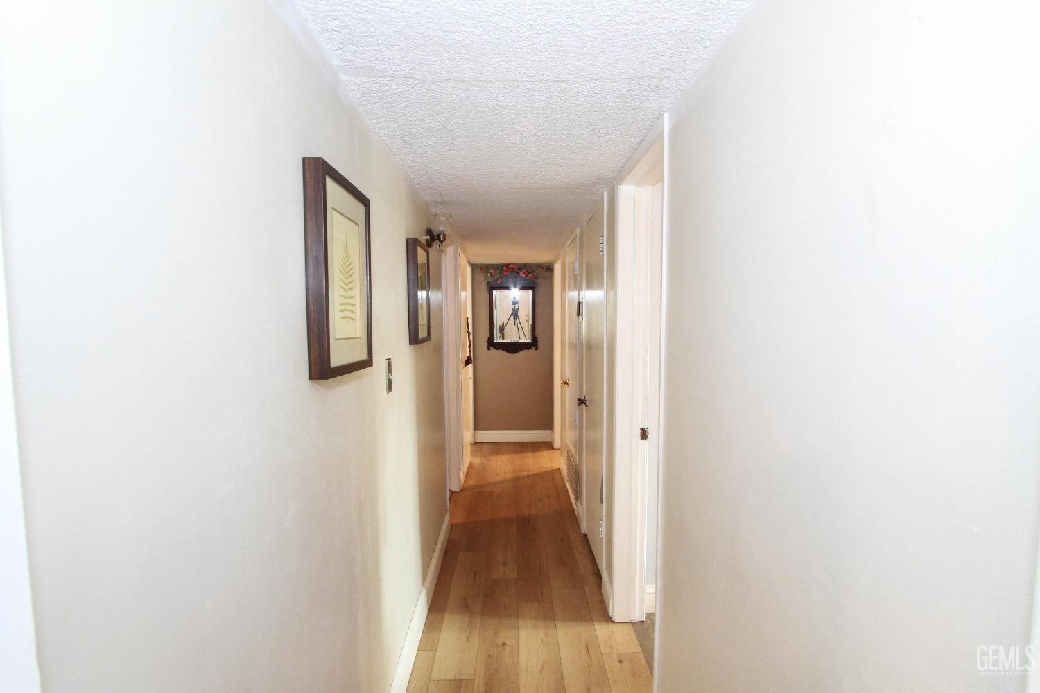 Undisclosed Address Bakersfield, CA 93306 - Photo 10 of 19 a view of a hallway with wooden floor