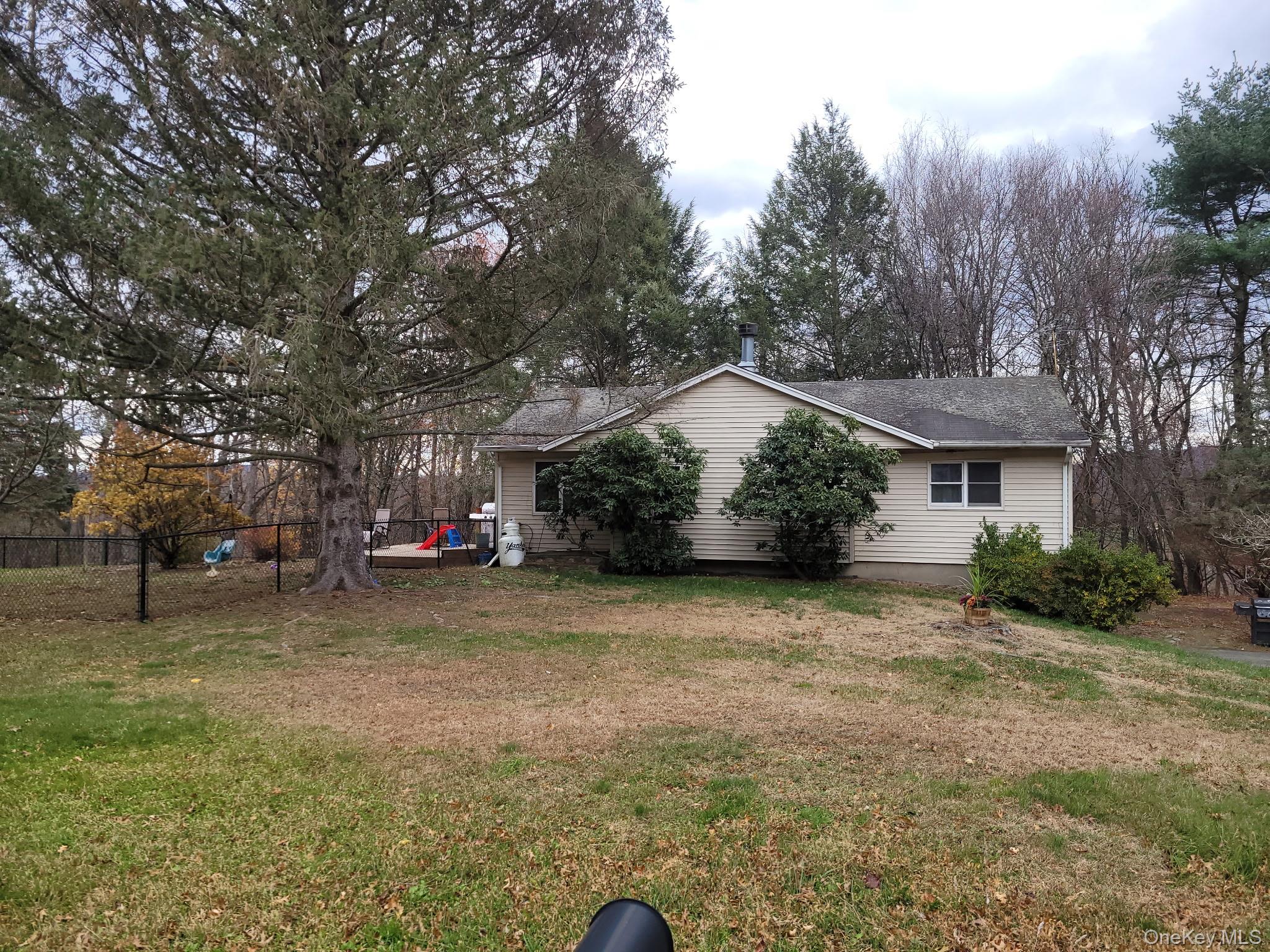 a view of a house with a backyard