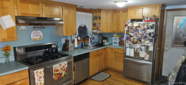 a kitchen with stainless steel appliances granite countertop a refrigerator and a stove top oven