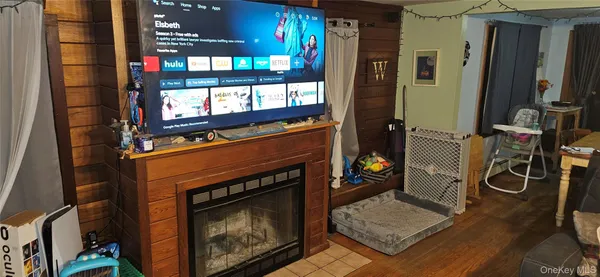 a living room with furniture a fireplace and gym equipment