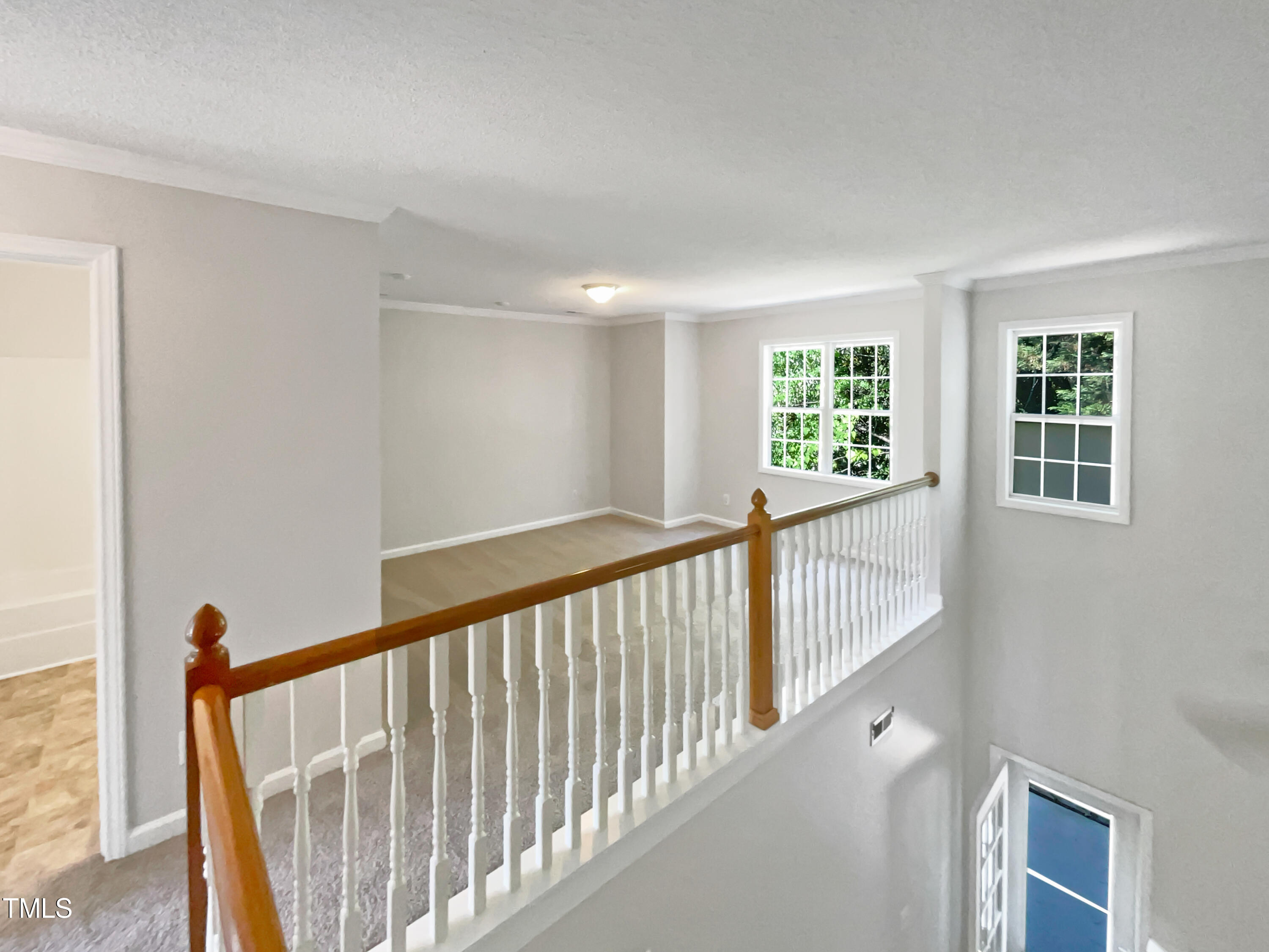 4117 Beaufain Street Raleigh, NC 27604 - Photo 15 of 24 a view of staircase with white walls and windows