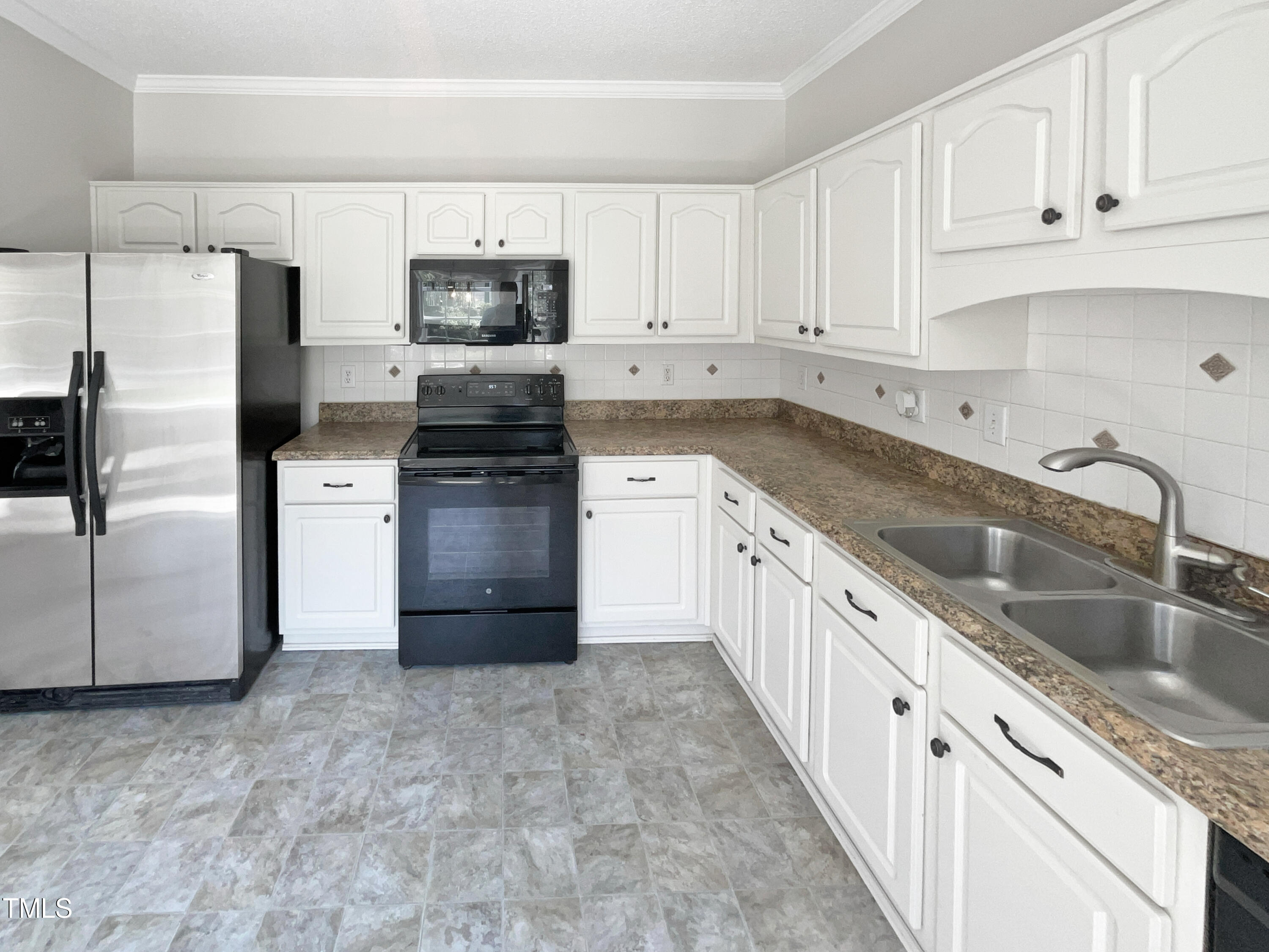4117 Beaufain Street Raleigh, NC 27604 - Photo 2 of 24 a kitchen with granite countertop a refrigerator stove and sink
