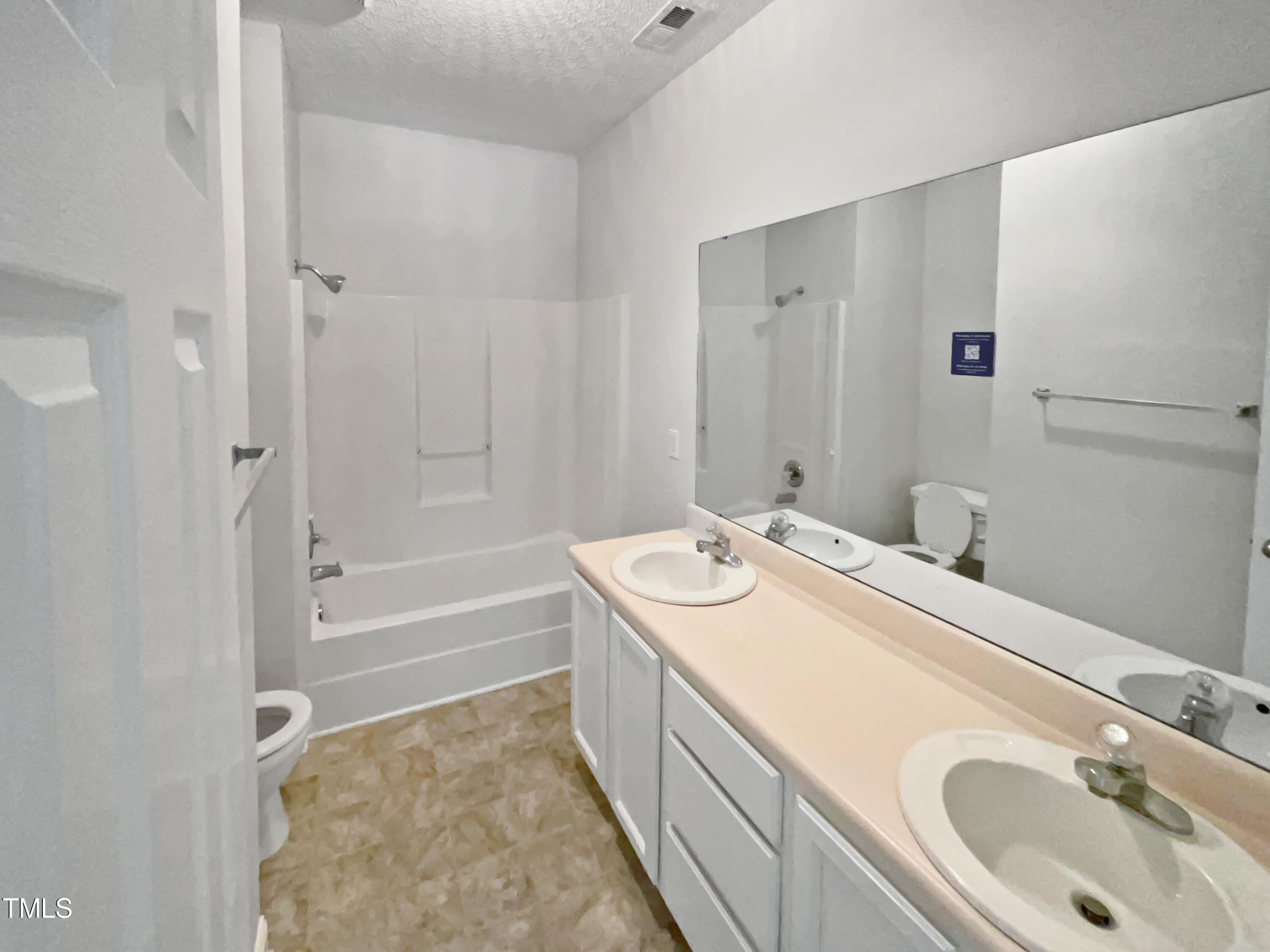 4117 Beaufain Street Raleigh, NC 27604 - Photo 5 of 24 a spacious bathroom with a tub sink and mirror