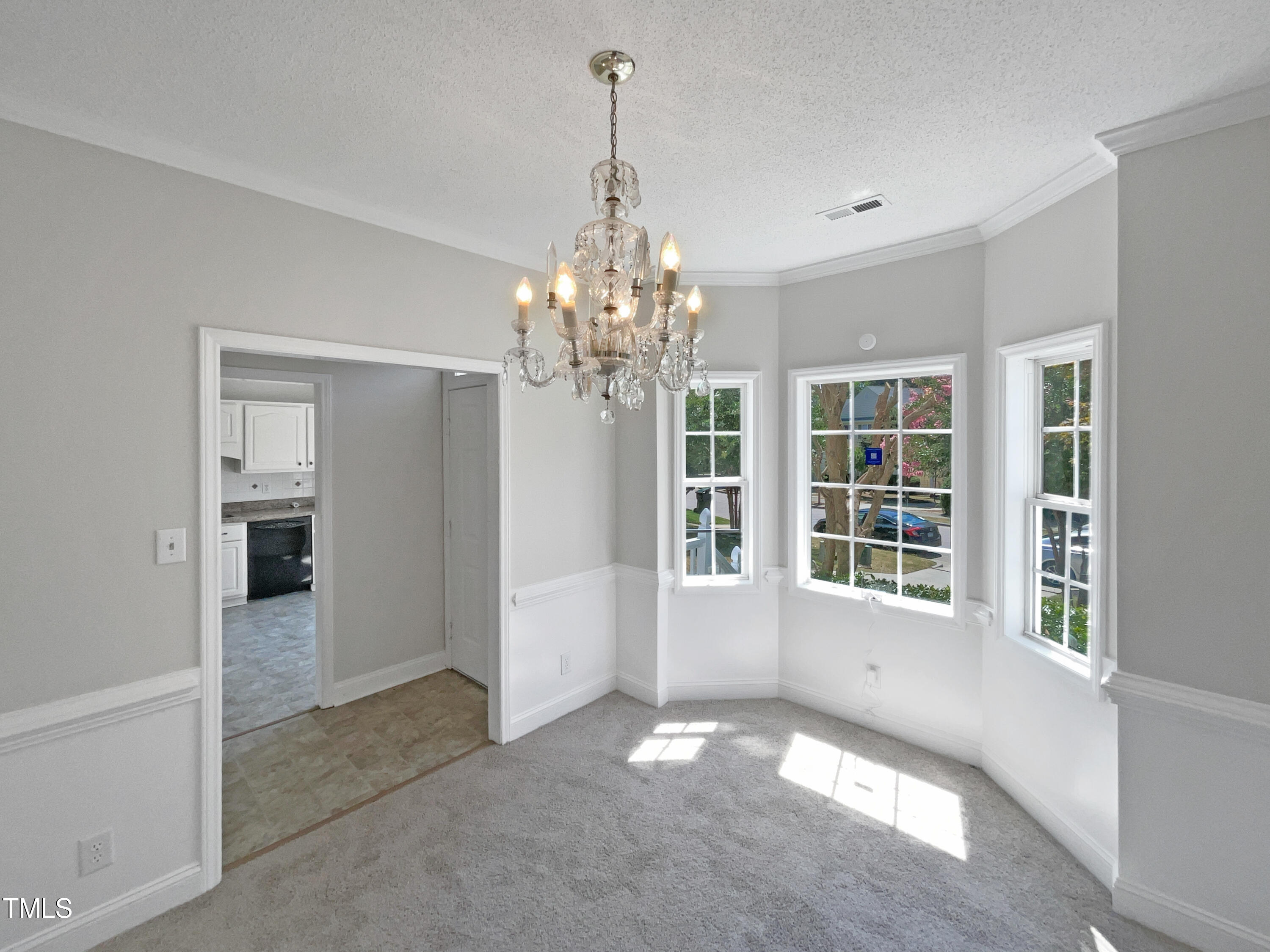 4117 Beaufain Street Raleigh, NC 27604 - Photo 9 of 24 a view of a big room with windows and chandelier