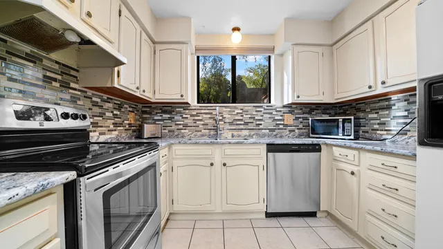 a kitchen with cabinets appliances and a sink