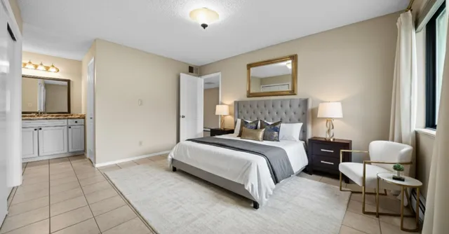 a spacious bedroom with a bed and a couch