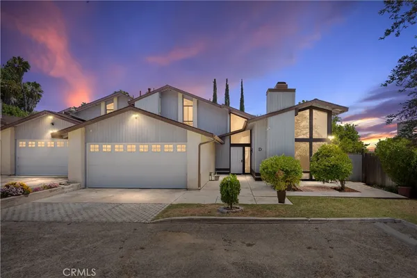 a front view of a house with a yard and a garage