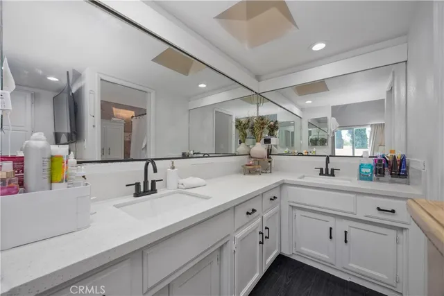 a spacious bathroom with a sink and a mirror