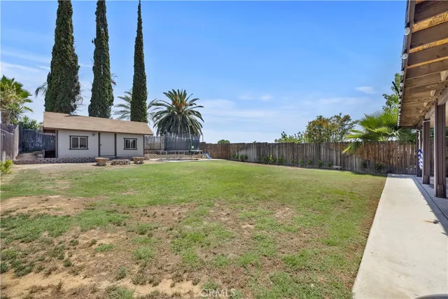 a view of a lake with a big yard and palm trees