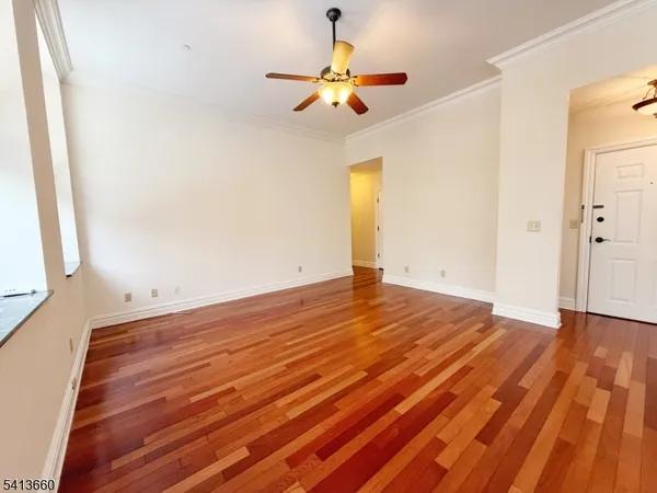a view of empty room with wooden floor