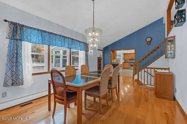 a view of a dining room with furniture window and wooden floor