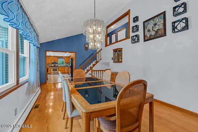 a dining room with furniture and a chandelier
