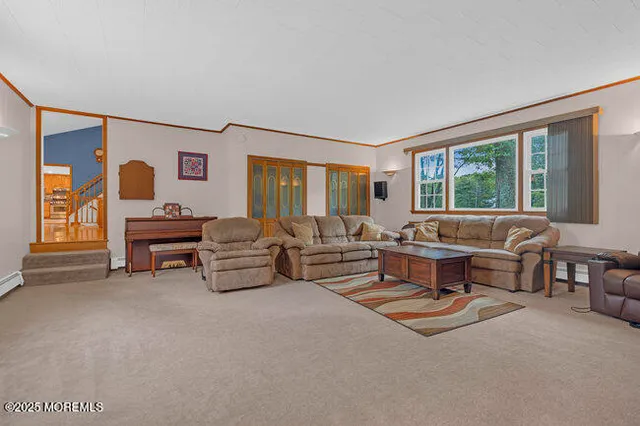 a living room with furniture and large windows