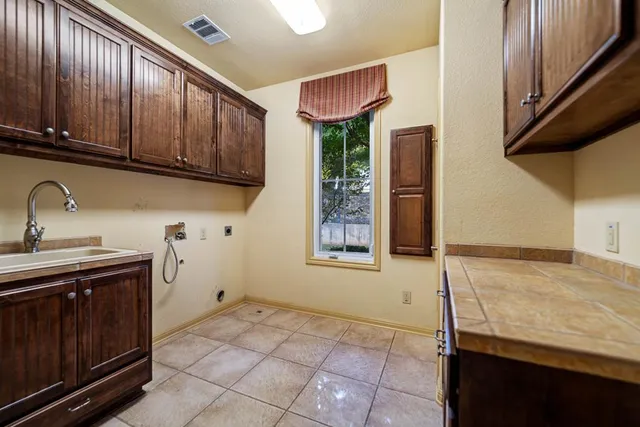 a house view with swimming pool and trees in the background