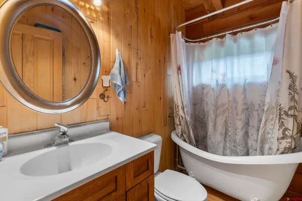 a bathroom with a sink a mirror a toilet and a mirror