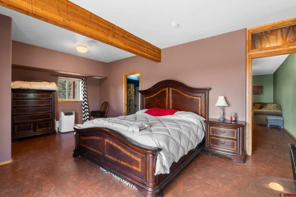 a bedroom with a bed and a dresser