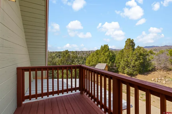 a view of balcony with wooden floor