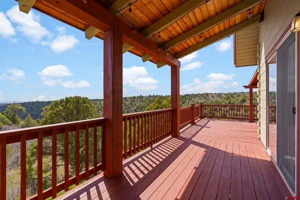 a view of a balcony with wooden floor