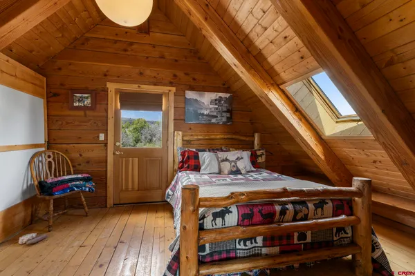 a bedroom with furniture and a wooden floor