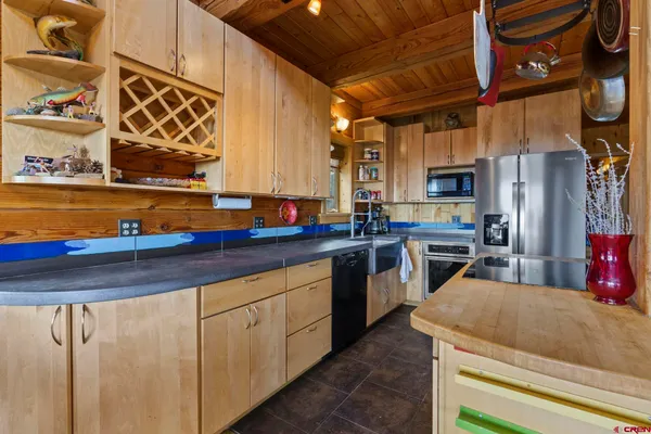 a kitchen with stainless steel appliances a sink and cabinets
