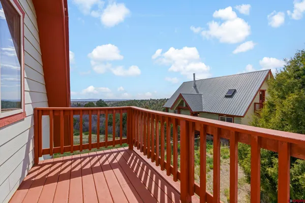 a view of balcony with wooden floor