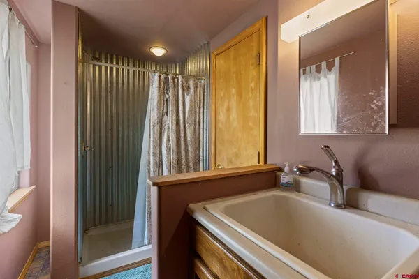 a bathroom with a tub and sink