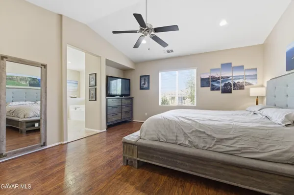 a bedroom with a large bed and a large window