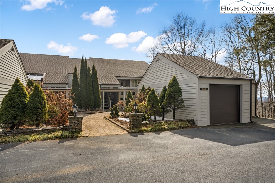 404 Moon Run, Unit D Linville, NC 28646 - Photo 1 of 27 a view of a house with sitting area and garden