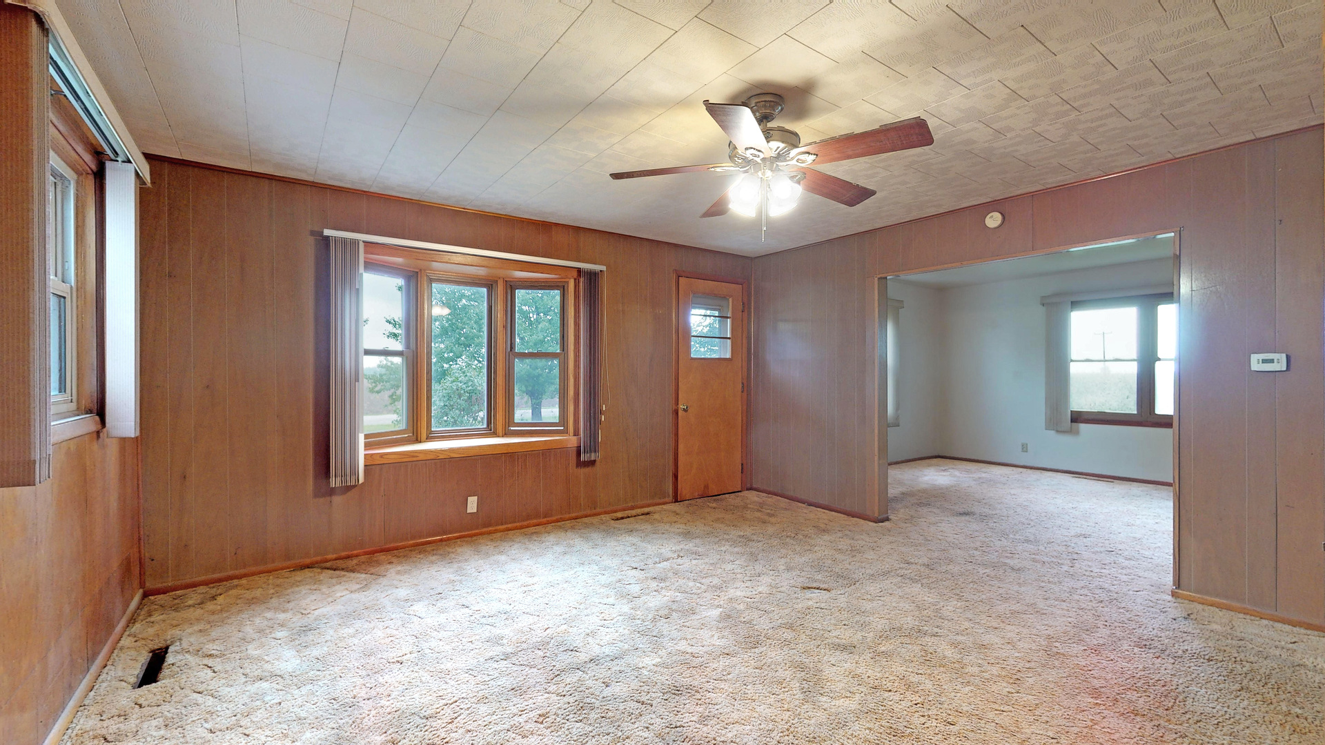 10909 Payne Road Marengo, IL 60152 - Photo 6 of 44 a view of an empty room with window and chandelier fan