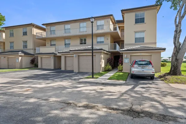 a car parked in front of a white building