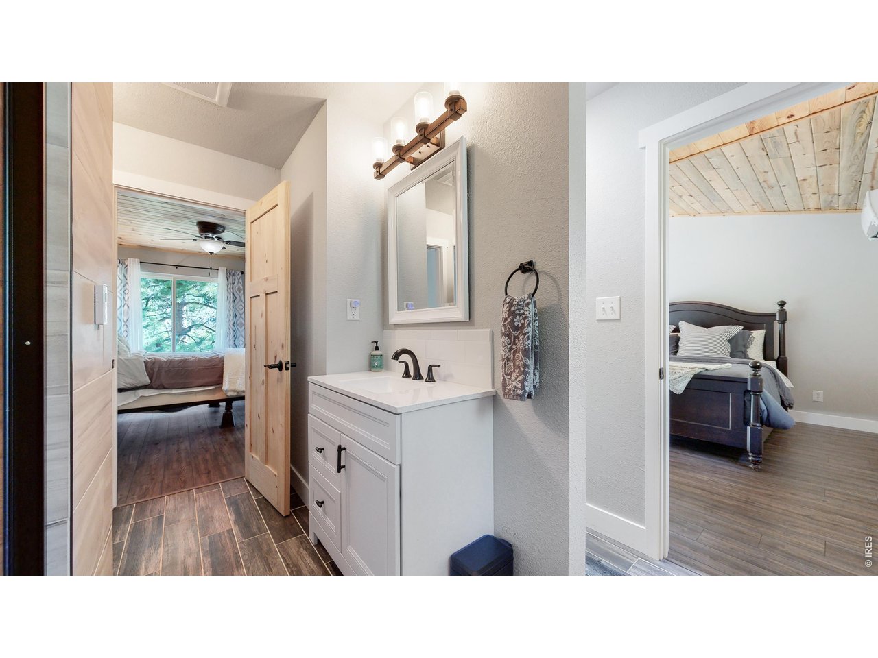 1268 Spring Valley Road Bellvue, CO 80512 - Photo 22 of 33 a bathroom with a sink a mirror and a view of bathroom