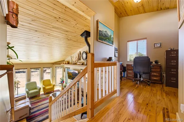 a living room with wooden floor and furniture