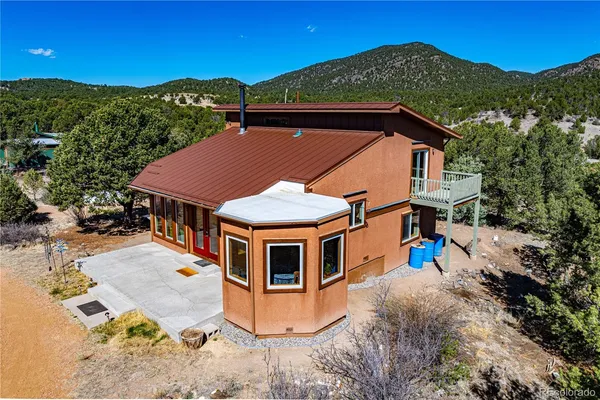 an aerial view of a house with a yard