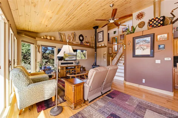 a living room with furniture a rug and a large window