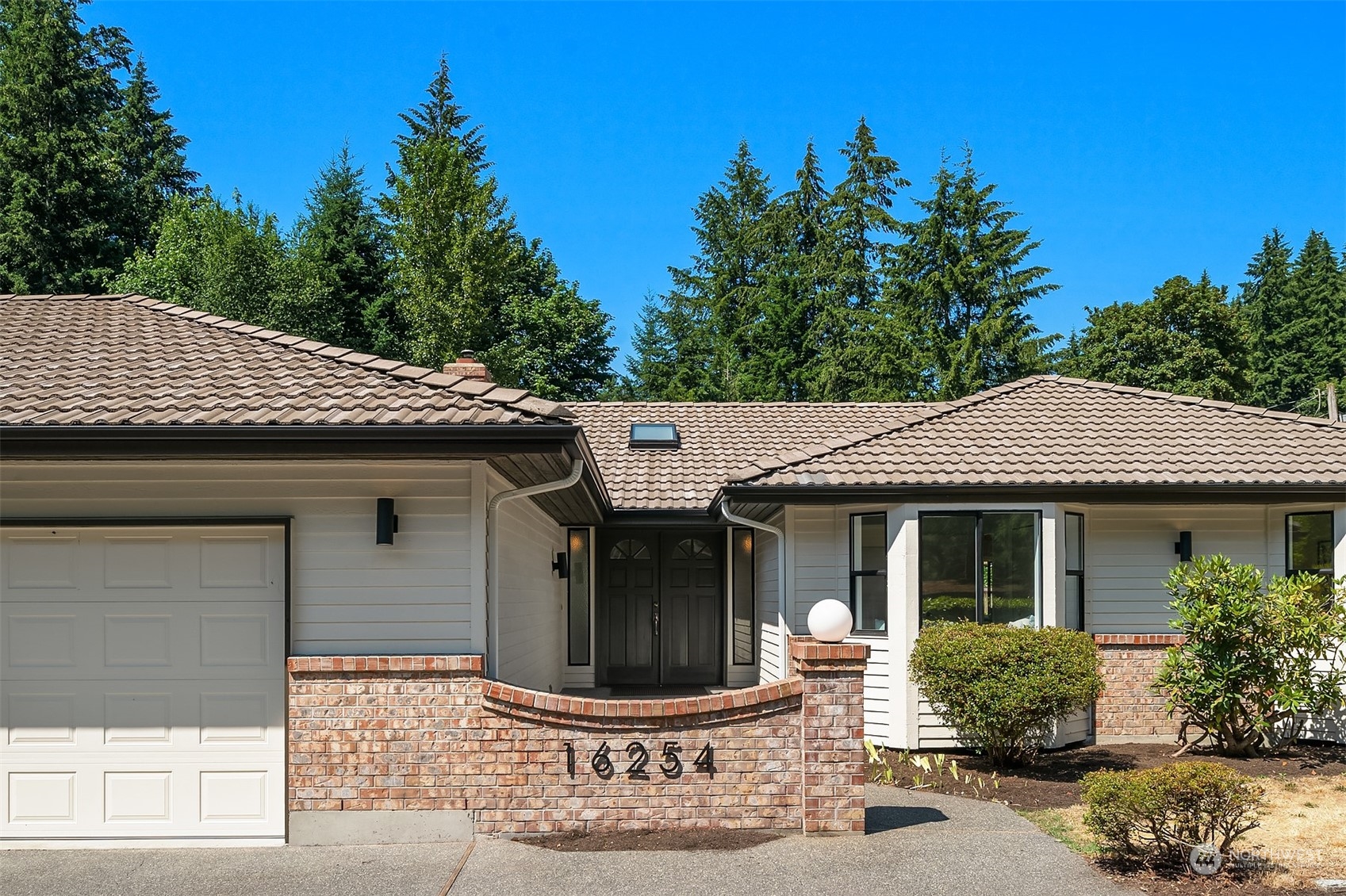16254 Southeast 144th Street Renton, WA 98059 - Photo 1 of 29 a front view of a house with garden