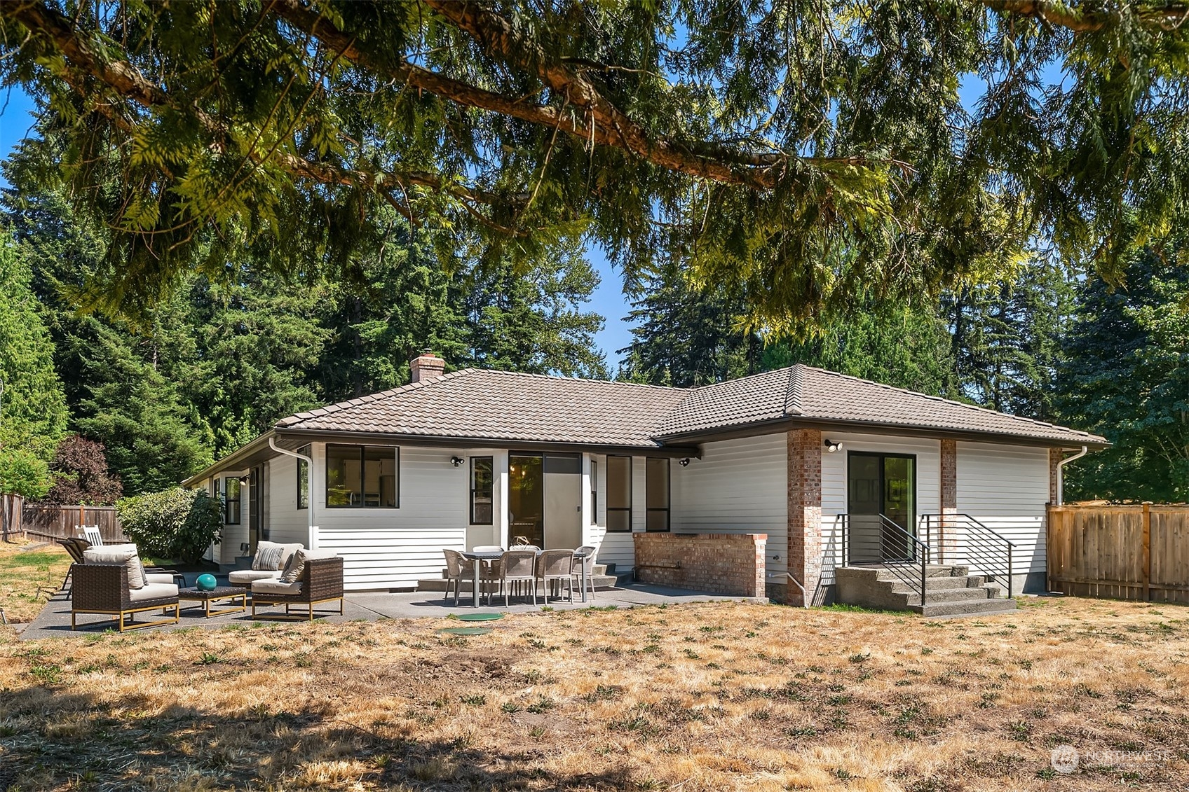 16254 Southeast 144th Street Renton, WA 98059 - Photo 24 of 29 a front view of a house with yard outdoor seating and barbeque oven