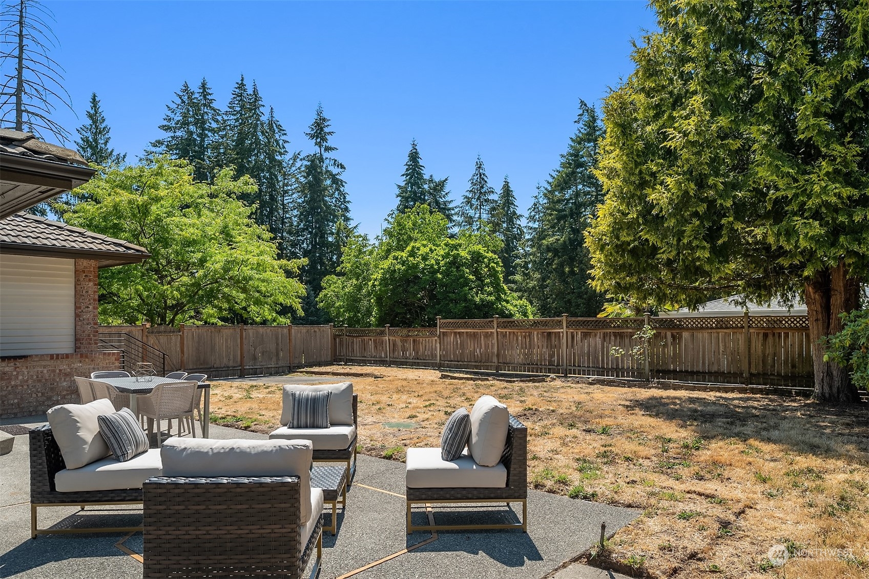 16254 Southeast 144th Street Renton, WA 98059 - Photo 25 of 29 a view of a patio with couches chairs and a fire pit with large tree