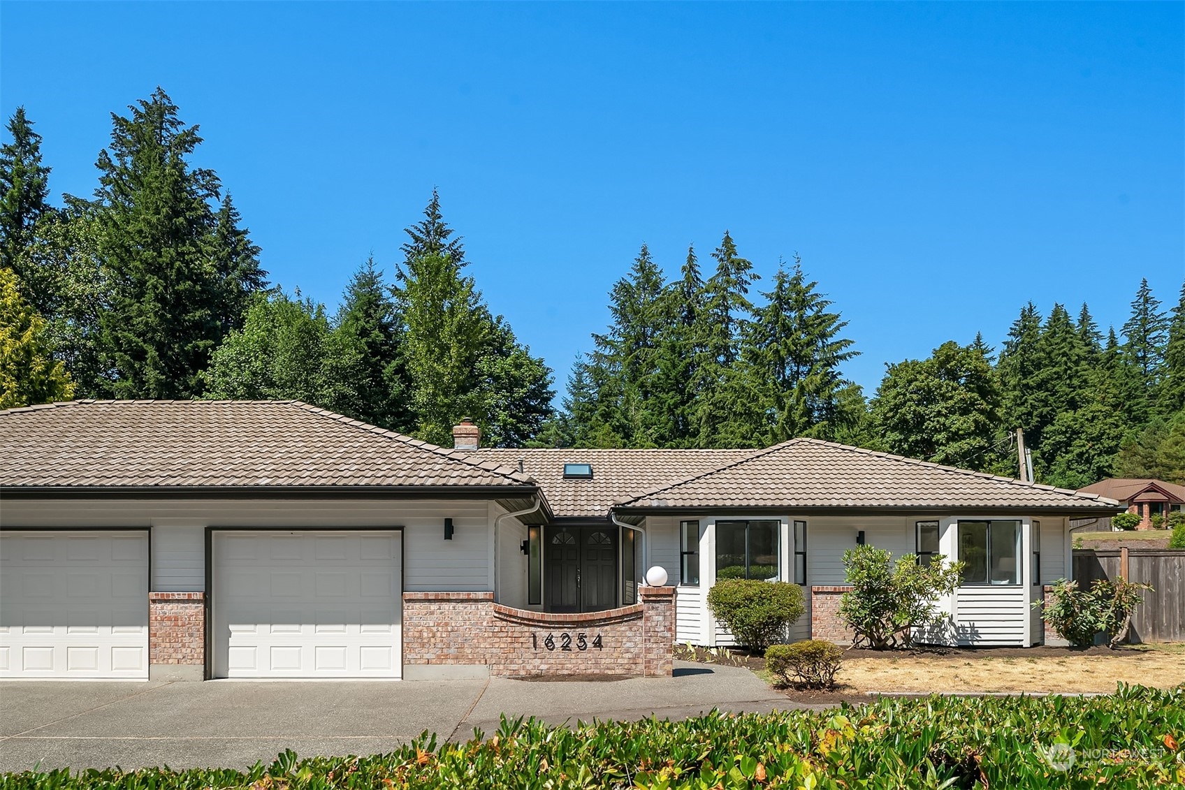 16254 Southeast 144th Street Renton, WA 98059 - Photo 26 of 29 a front view of a house with a garden